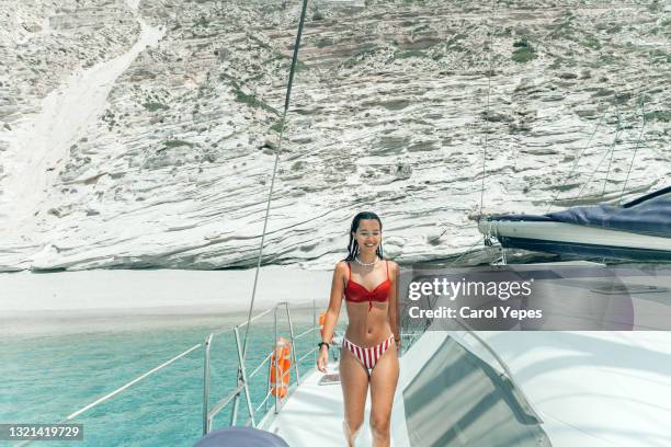 young woman sitting walking on catamaran in the mediterranean sea in summer - shade sail stock pictures, royalty-free photos & images