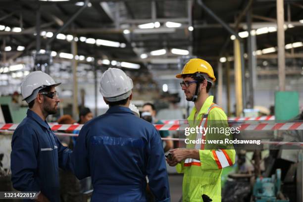 group of technical worker meeting and planning talking while standing in the place of work site - machinekamer stockfoto's en -beelden