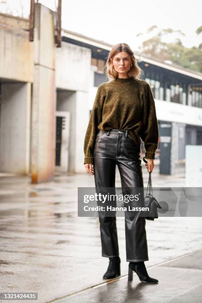 Shenise Breslin wering Camilla and Marc jumper, YSL black bag, Ducie London jeans and Tony Bianco boots at Afterpay Australian Fashion Week 2021 on...