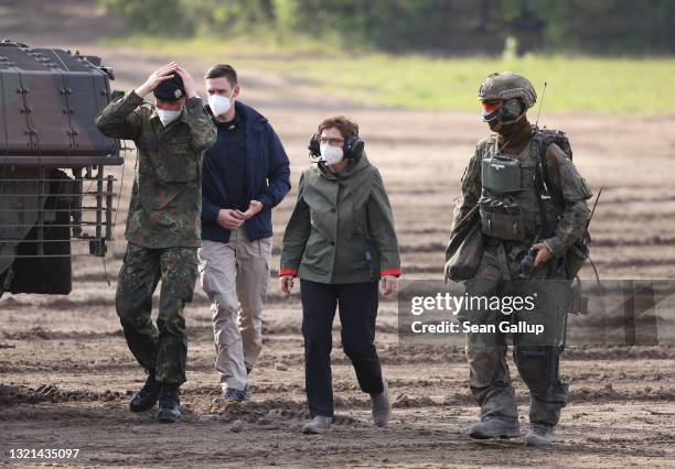 German Defense Minister Annegret Kramp-Karrenbauer walks with Bundeswehr troops during a demonstration of capabilities by the Panzerlehrbrigade 9...