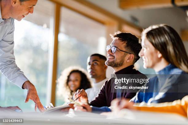 Helping Others In Class University Students Helping Each Other Photos and Premium High Res ...