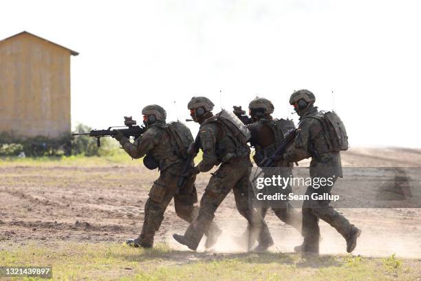 Infantry soldiers of the Bundeswehr attack a position during a demonstration of capabilities by the Panzerlehrbrigade 9 tank training brigade on June...