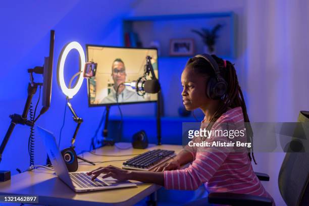 young black woman recording a business podcast - live streaming stockfoto's en -beelden