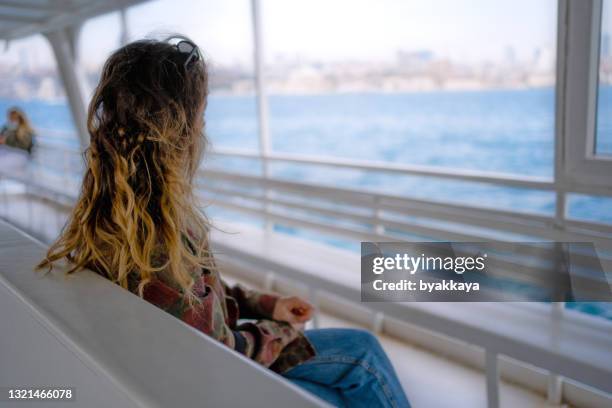 woman with protective face mask on the ferry - commuter ferry stock pictures, royalty-free photos & images