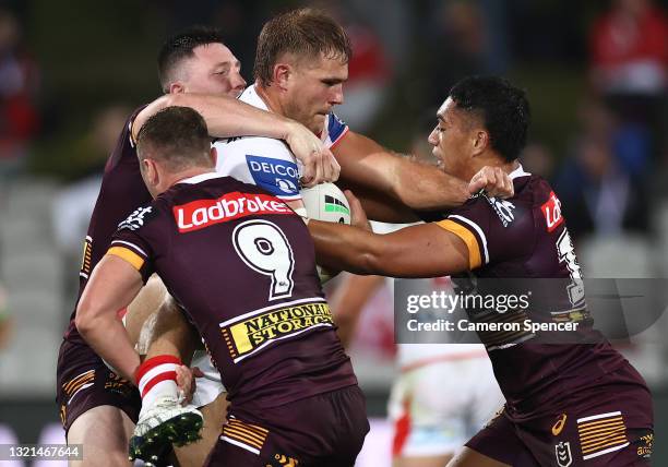 Jack De Belin of the Dragons is tackled during the round 13 NRL match between the St George Illawarra Dragons and the Brisbane Broncos at Netstrata...