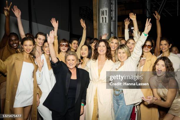 Delta Goodrem poses with models and designers Vanessa Manning, Cheryl Manning, and Gabrielle Manning at backstage after of the Manning Cartell show...