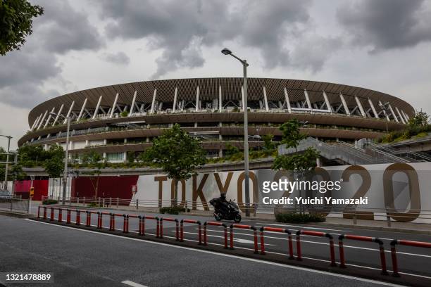 Man drives past the New National Stadium, the main stadium for the Tokyo Olympics, on June 03, 2021 in Tokyo, Japan. Tokyo 2020 president Seiko...