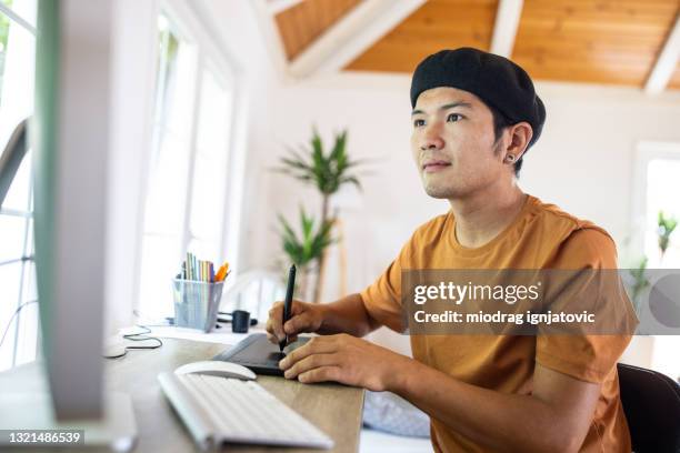 graphic designer using drawing tablet for pc to put his ideas to work - draw attention stock pictures, royalty-free photos & images