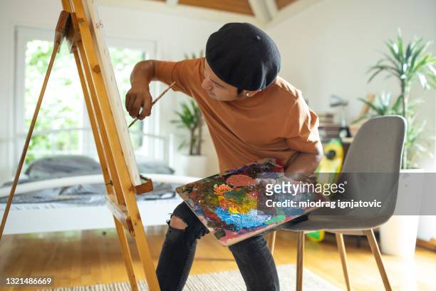 japanese male painter painting on canvas in bedroom at home - painter beret stock pictures, royalty-free photos & images