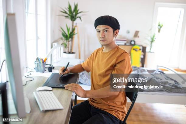 graphic designer using drawing tablet for pc to put his ideas to work - only japanese stock pictures, royalty-free photos & images