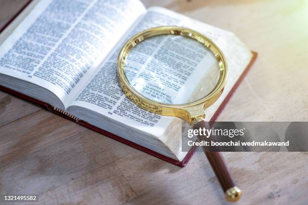 open book and magnifying glass. - old book pages stock pictures, royalty-free photos & images