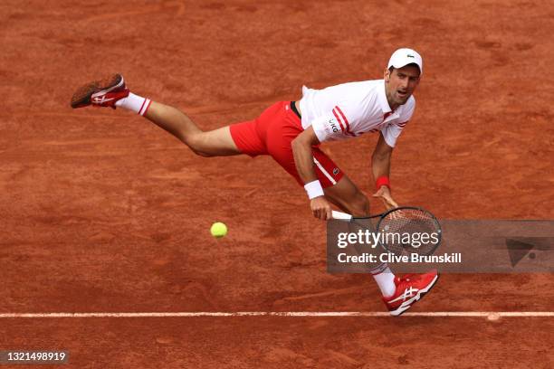 Novak Djokovic of Serbia plays a backhand during his mens second round match against Pablo Cuevas of Uruguay during day five of the 2021 French Open...