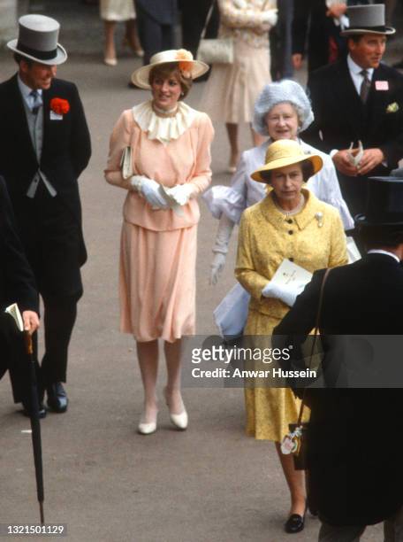 Lady Diana Spencer, wearing a peach coloured crepe suit with a wrap top jacket and cream ruffle neck blouse designed by Benny Ong and a yellow straw...