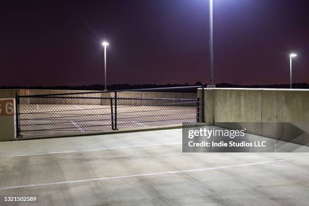 empty parking garage at night with streetlights - film noir stil stockfoto's en -beelden