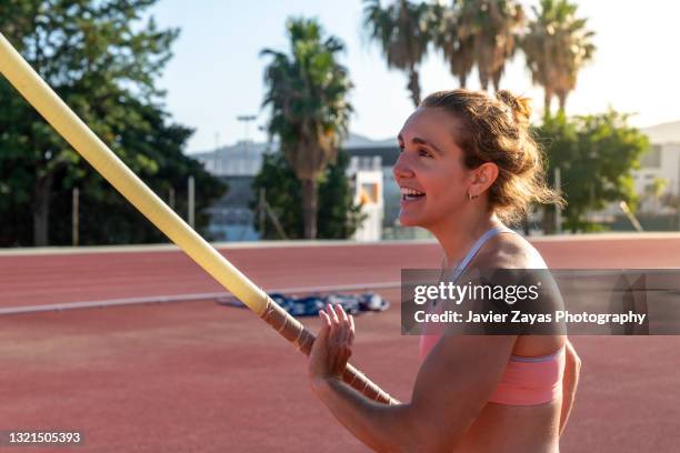 young woman pole-vaulting - womens high jump stock pictures, royalty-free photos & images