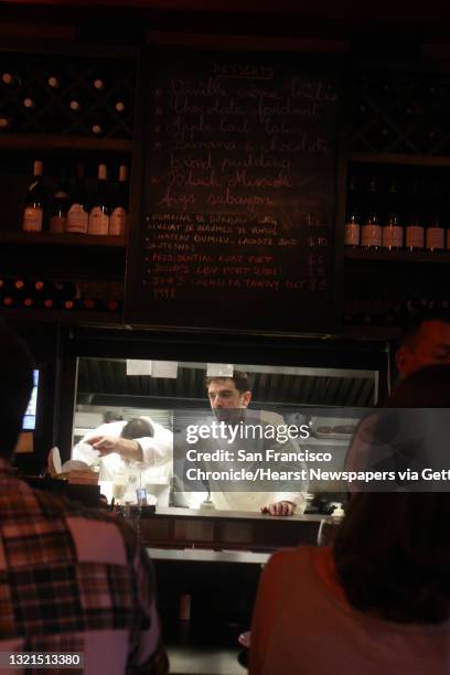 Owner/chef Thierry Clement preparing meals behind the counter at his restaurant, L'Ardoise, in the Duboce Triangle in San Francisco, Calif., during...