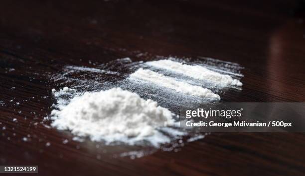 high angle view of powdered sugar on table - sachet stockfoto's en -beelden
