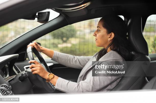 businesswoman driving to the office - indian ethnicity car stock pictures, royalty-free photos & images