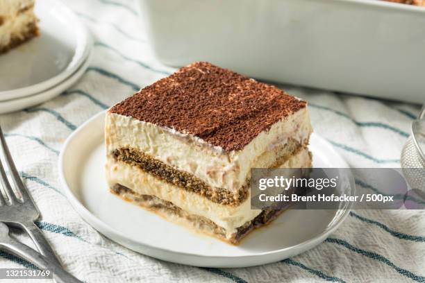 close-up of cake in plate on table - tiramisu stock pictures, royalty-free photos & images