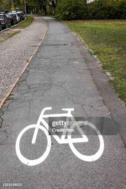 bicycle symbol on a bike path - bicycle lane stock pictures, royalty-free photos & images
