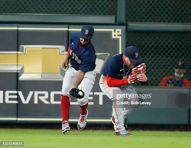 Danny Santana of the Boston Red Sox and Alex Verdugo avoid colliding with each other as Santana makes the catch in the first inning against the...