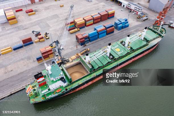 aerial view of a large cargo ship loading grain. - cereal boxes stock pictures, royalty-free photos & images