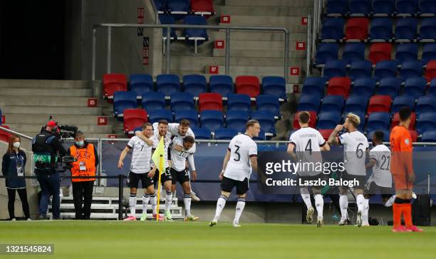 Florian Wirtz of Germany celebrates with Salih Ozcan and Lukas Nmecha after scoring their side's first goal during the 2021 UEFA European Under-21...