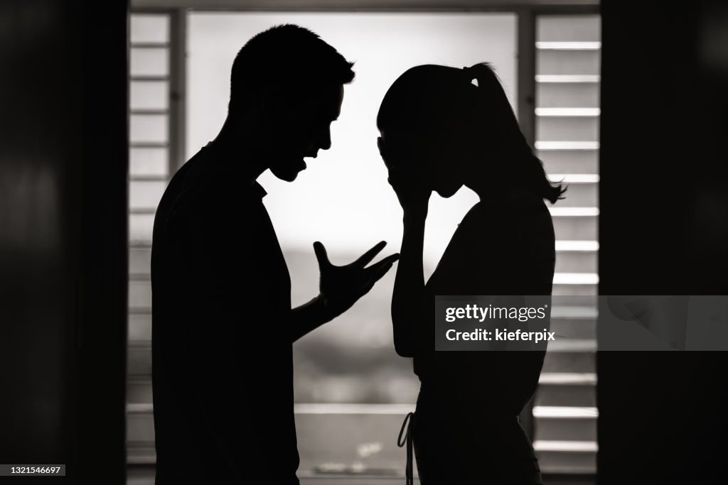 Argument. Man and woman having an argument at home.