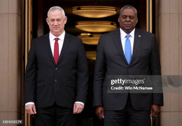 Secretary of Defense Lloyd Austin and Israeli Minister of Defense Benny Gantz stand at attention during the playing of the Israeli national anthem at...