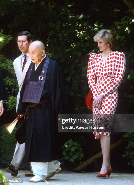 Prince Charles, Prince of Wales and Diana, Princess of Wales, wearing a white dress with large red polka dots or 'rising suns' from Tatters with a...