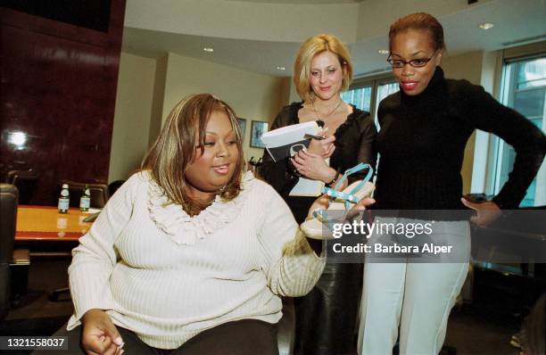 Star Jones checks out one of the shoes from the line she designed for sale at Payless Shoes, New York, October 22, 2002.