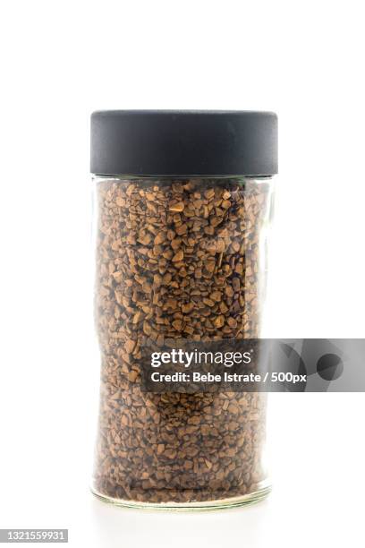 close-up of instant coffee in jar against white background - coffee powder stock-fotos und bilder