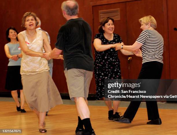 Ponnie Rasmussen dancing the swing with Bob Steel and Suzanna Yeh dancing with Ione Byrnes . Berkeley Folk Dancers, a club that started in 1941, at...