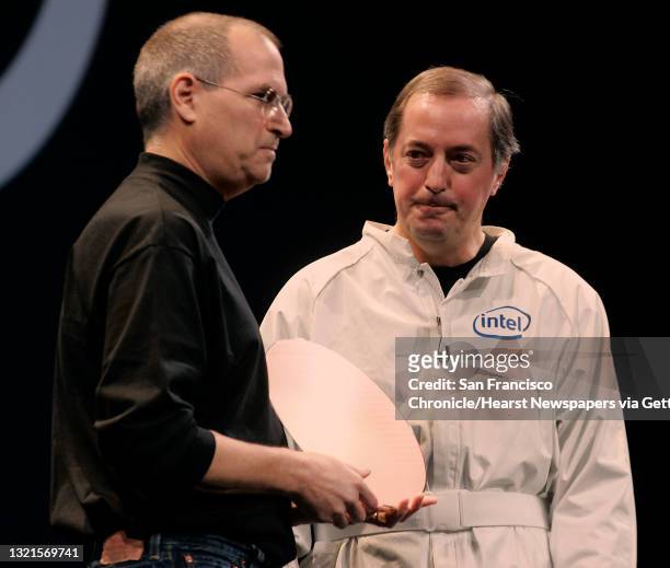 Apple Computer CEO Steve Jobs announces using the Intel processor in Mac computers in his keynote speech at the Moscone Center. At right is CEO Paul...