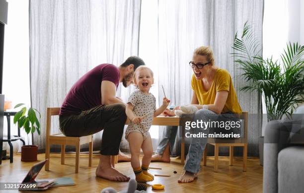 family bonding: mom, dad and daughter spending quality time at  home - family time stock pictures, royalty-free photos & images