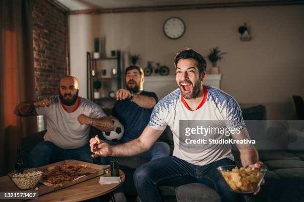 friends watching sport on tv - sports man cave stock pictures, royalty-free photos & images