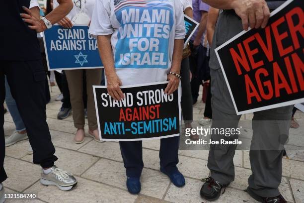 People stand together during an interfaith Rally Against Anti-Semitism, hosted by Greater Miami Jewish Federation at the Holocaust Memorial Miami...