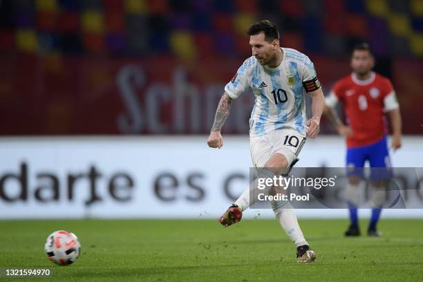 Lionel Messi of Argentina takes a penalty kick to score the opening goal during a match between Argentina and Chile as part of South American...