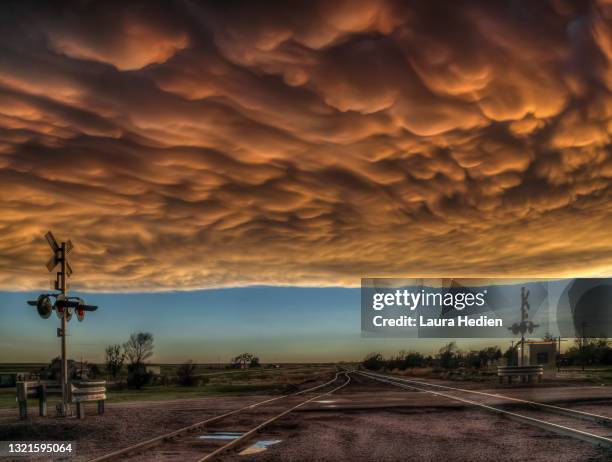 mammatus clouds on the great plains with railroad items - mammatus cloud stock pictures, royalty-free photos & images