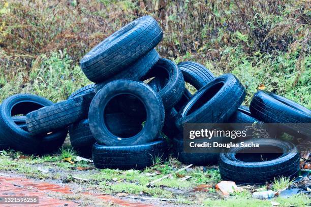 abandoned old tires in the ghetto back alley - ghetto trash stock pictures, royalty-free photos & images