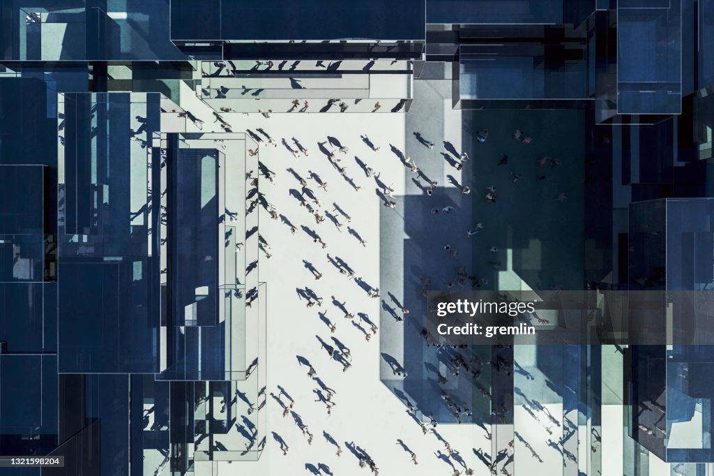 Modern glass office building with business people from above