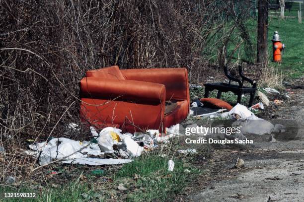 trash and old furniture dumped on a dead end alley - ugliness stock-fotos und bilder