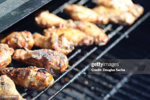 grilled chicken wings in the smoker grill - bbq chicken wings stock pictures, royalty-free photos & images