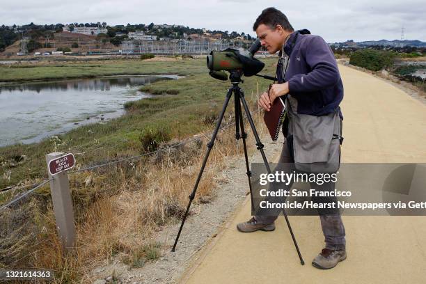 Naturalist John Muir Laws with his telescope at Heron's Head Park in San Francisco, Calif., as he takes out his sketchbook looking for birds to draw...