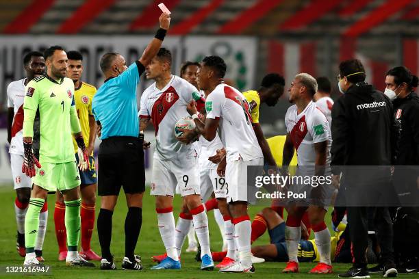 Referee Wilton Sampaio shows a red card to Miguel Trauco of Peru during a match between Peru and Colombia as part of South American Qualifiers for...