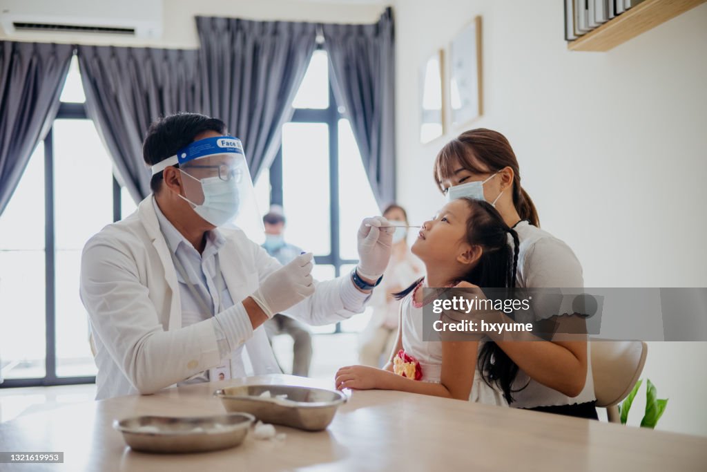 Young girl getting a nasal swab for coronavirus test