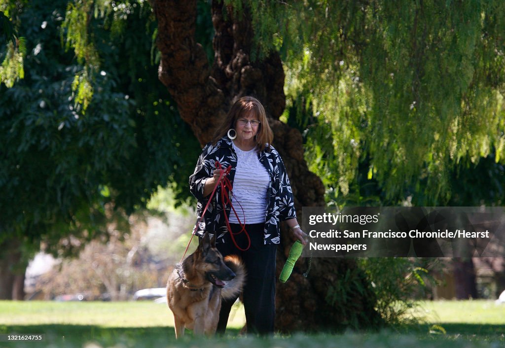 President Joan Cannelli of Golden State German Shepherd Rescue walks with four year old Drake at Cowell Community Park in Concord, Calif., on Monday, June 17, 2013. Joan had trigeminal neuralgia, a form of facial nerve pain, for about 5 years following