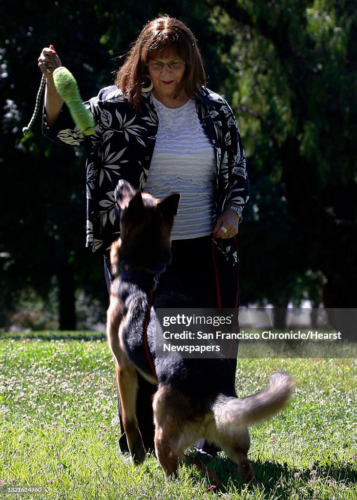 President Joan Cannelli of Golden State German Shepherd Rescue plays with four year old Drake at Cowell Community Park in Concord, Calif., on Monday, June 17, 2013. Joan had trigeminal neuralgia, a form of facial nerve pain, for about 5 years following