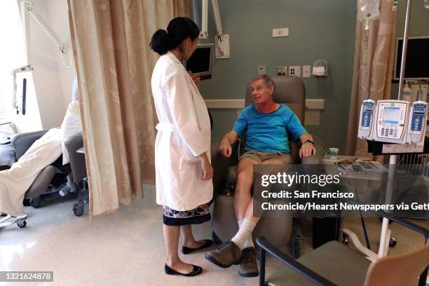 Founder Bernice Kwong, M.D. , of supportive dermato oncology checks the condition of the neck of cancer patient Michael Grupp at Stanford Cancer...