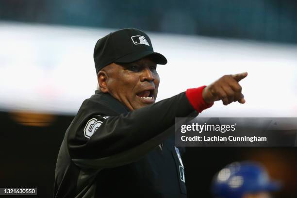 Umpire Laz Diaz talks to Chicago Cubs players and coaches in the dugout during the game against the San Francisco Giants at Oracle Park on June 03,...